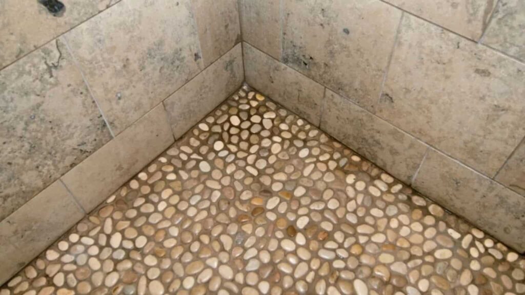 an image showing drainage issue in pebble tiles