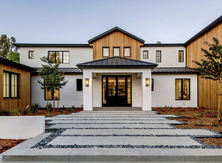 A white and black house and pathway to outside the house