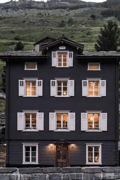 A black house with white shutter and warm lights
