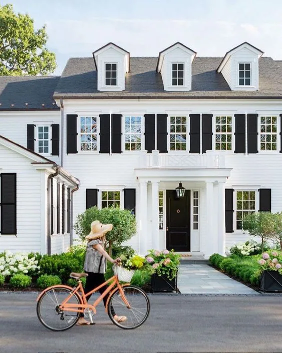 A white and black door and plants both of side white window