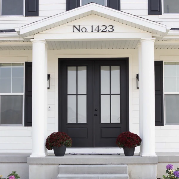 A white house and black door and black house number