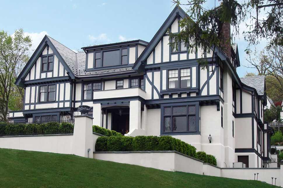 A gray house and black and white combination and black feamed windows and