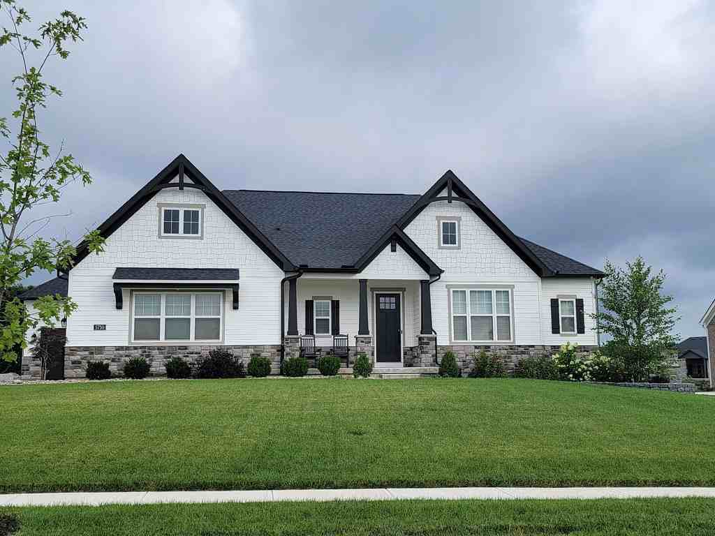 A white house and black roof and a mini garden