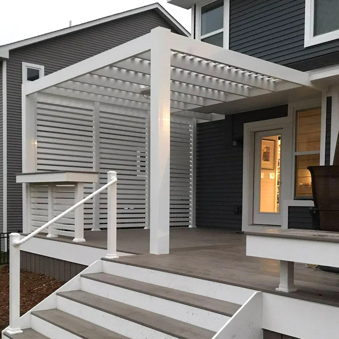 Black house with white pergola and white door