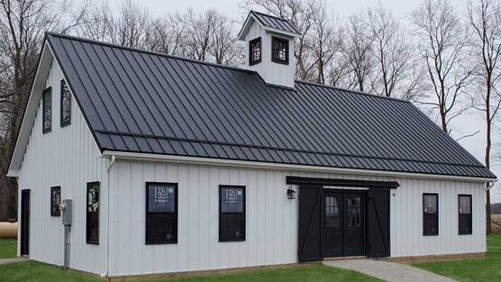 A white house with black roof and black windows and
