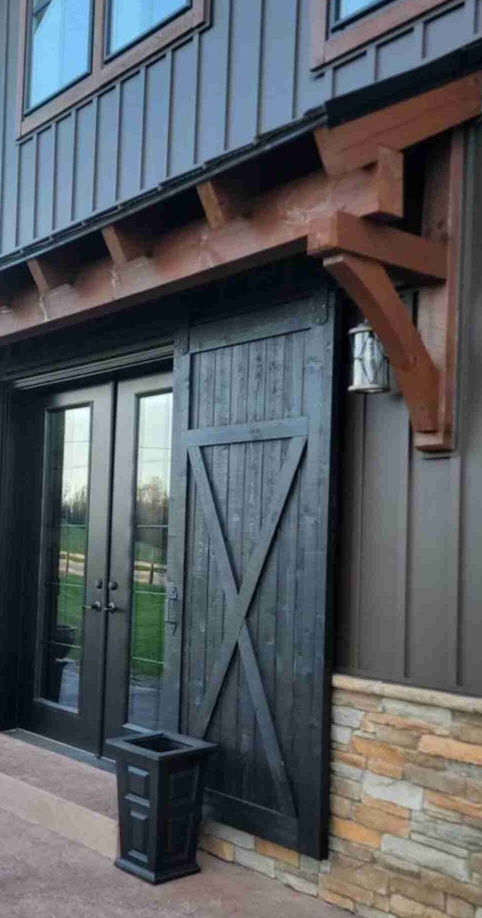 A dark grey house with black door 