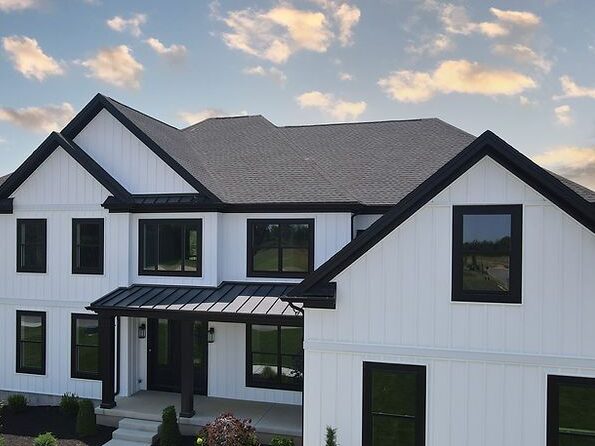 Black roof on white house with black windows 