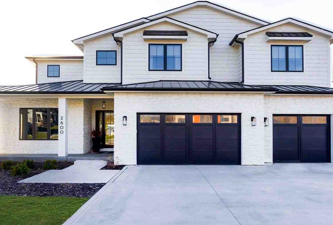 White house with black garage door and black trim and windows