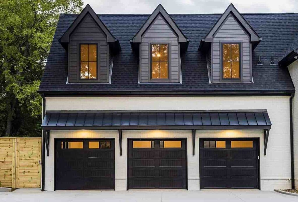 Black garage door with white house