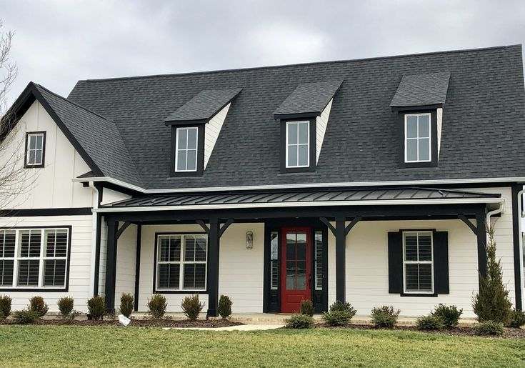 White house with black roof and white gutter and white windows