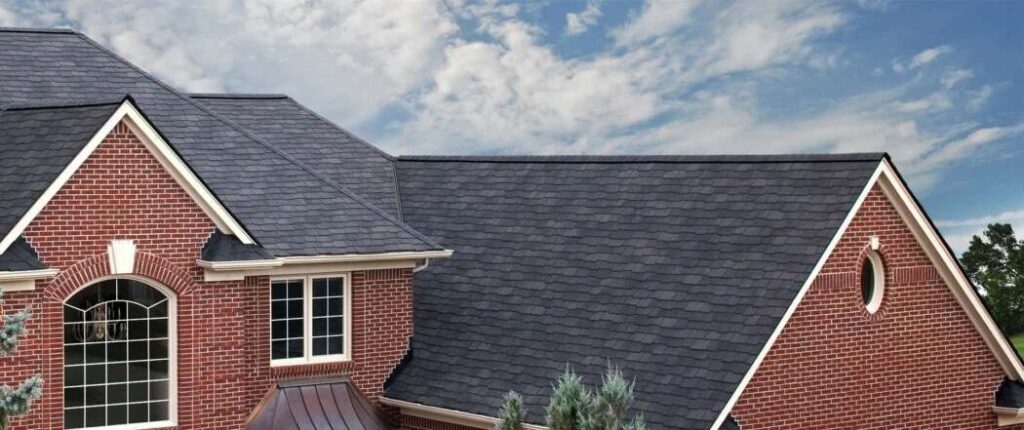 Charcoal shingles on red brick house with white trim