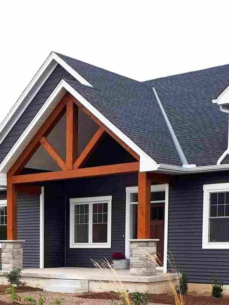 Dark blue house exterior with cedar gable roof and whitetrim