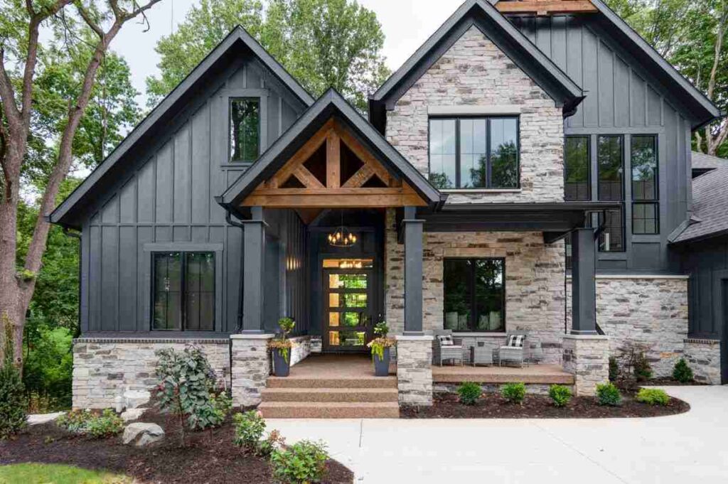 Dark blue house with stone sidling and gable roof