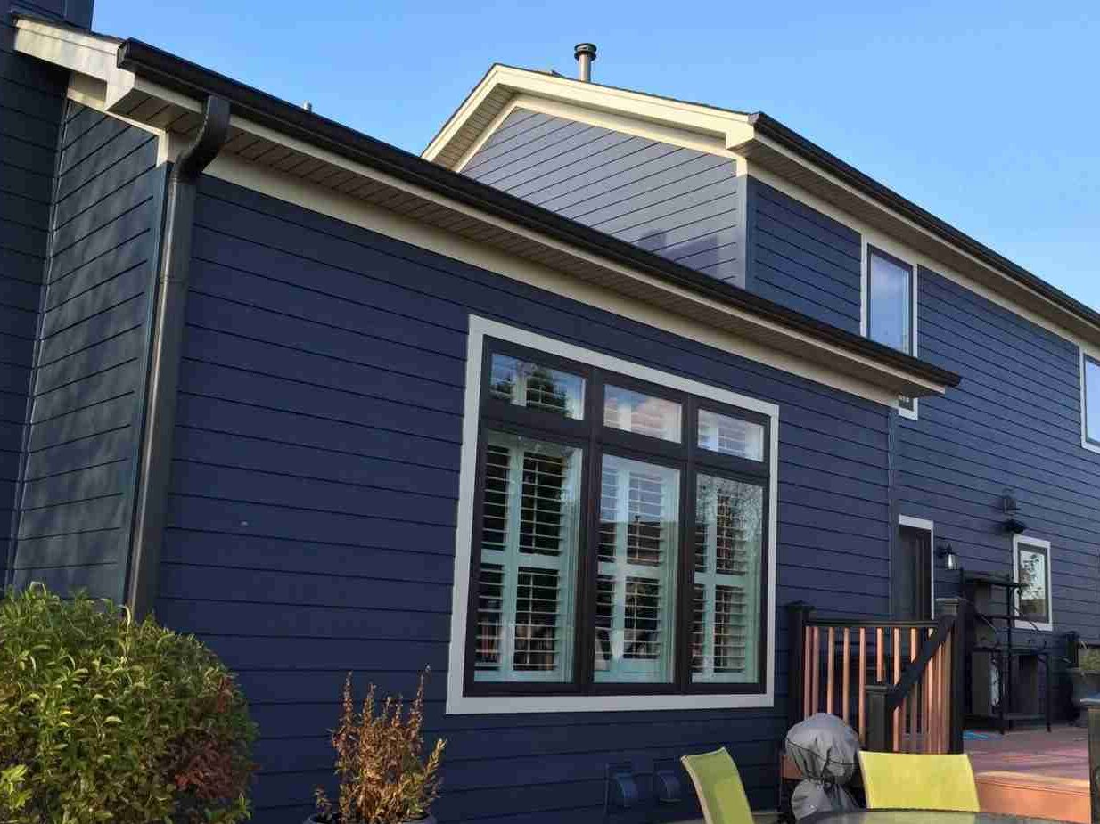 Blue house with black trim with white trim