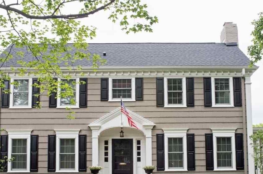 Tan house with black shutter and door and white trim