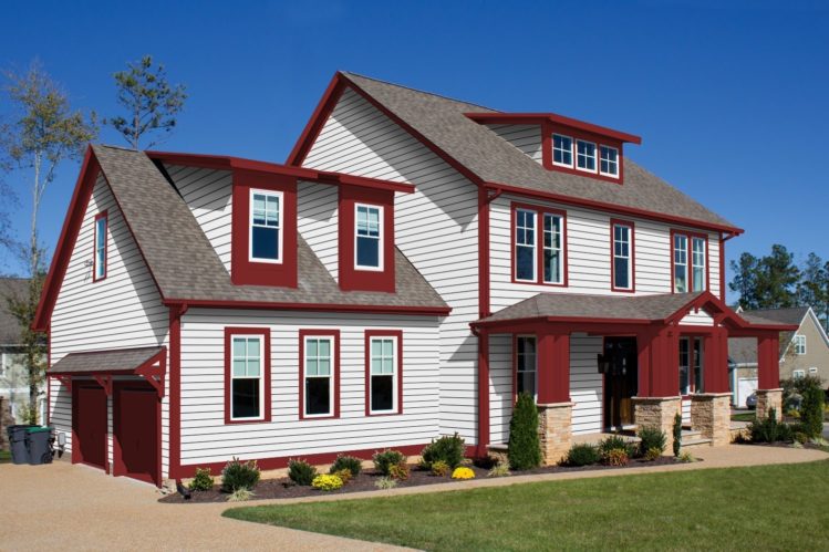 white house with red trim and white framed windows and garden otside of the house 