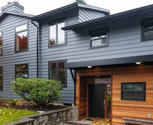 Light grey house with black trim and glass windows