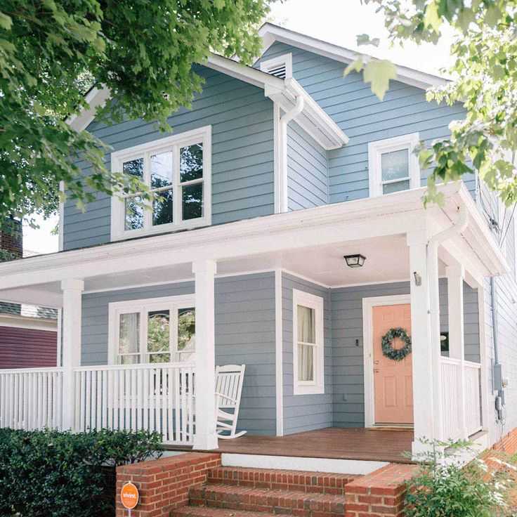 Light house with windows and pink door wooden porch