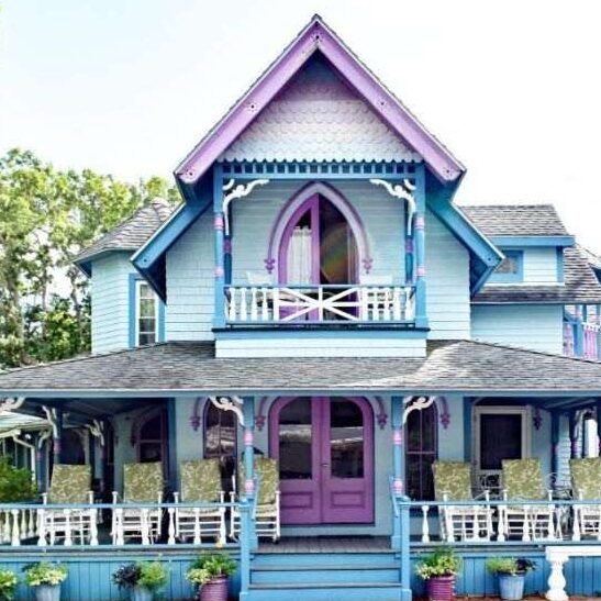 A blue house with violet undertones and white trim