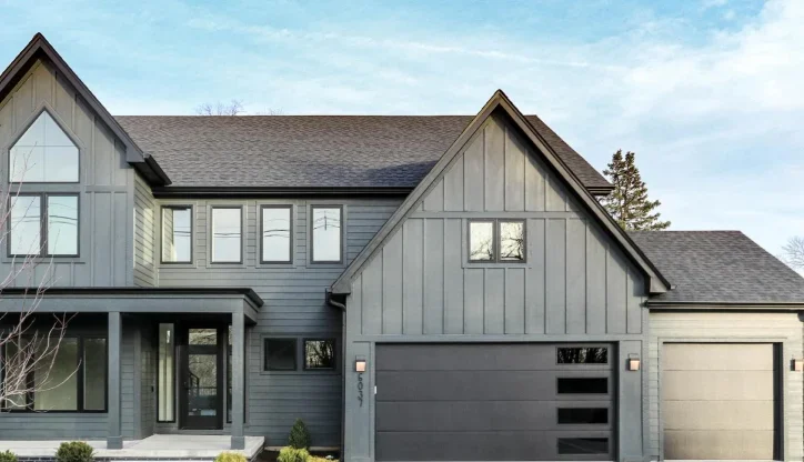 A grey house with dark grey house with black framed windows 