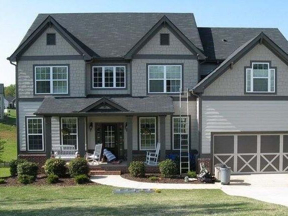 Light grey house with dark trim and with white windows 