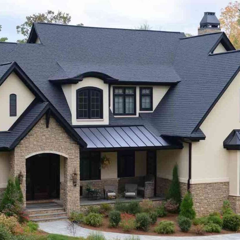 Light tan stucco with black windows and chair outside of the house