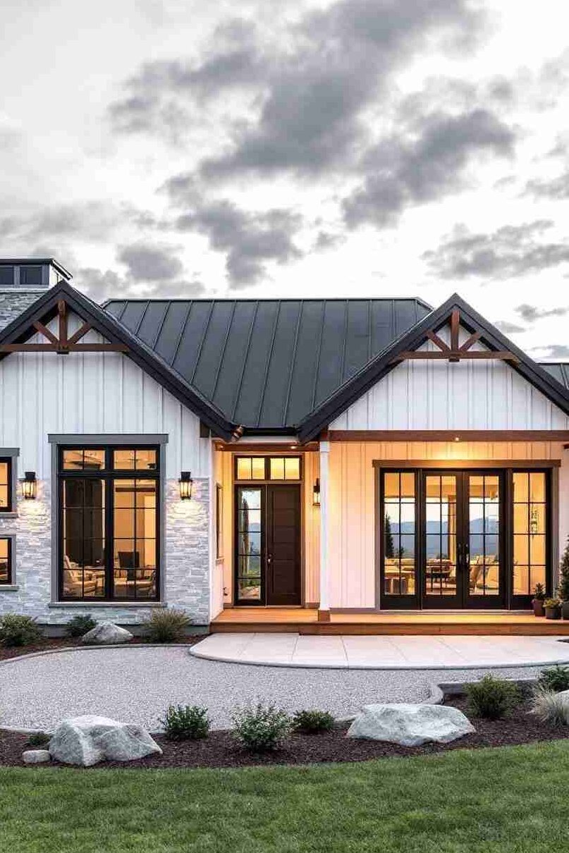 Metal black panels on white house and warm lights on the house