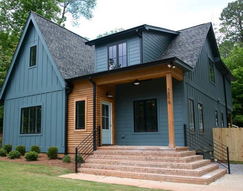 Navy blue house with wood accent and black railing