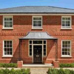 Red brick house with black trim featured image