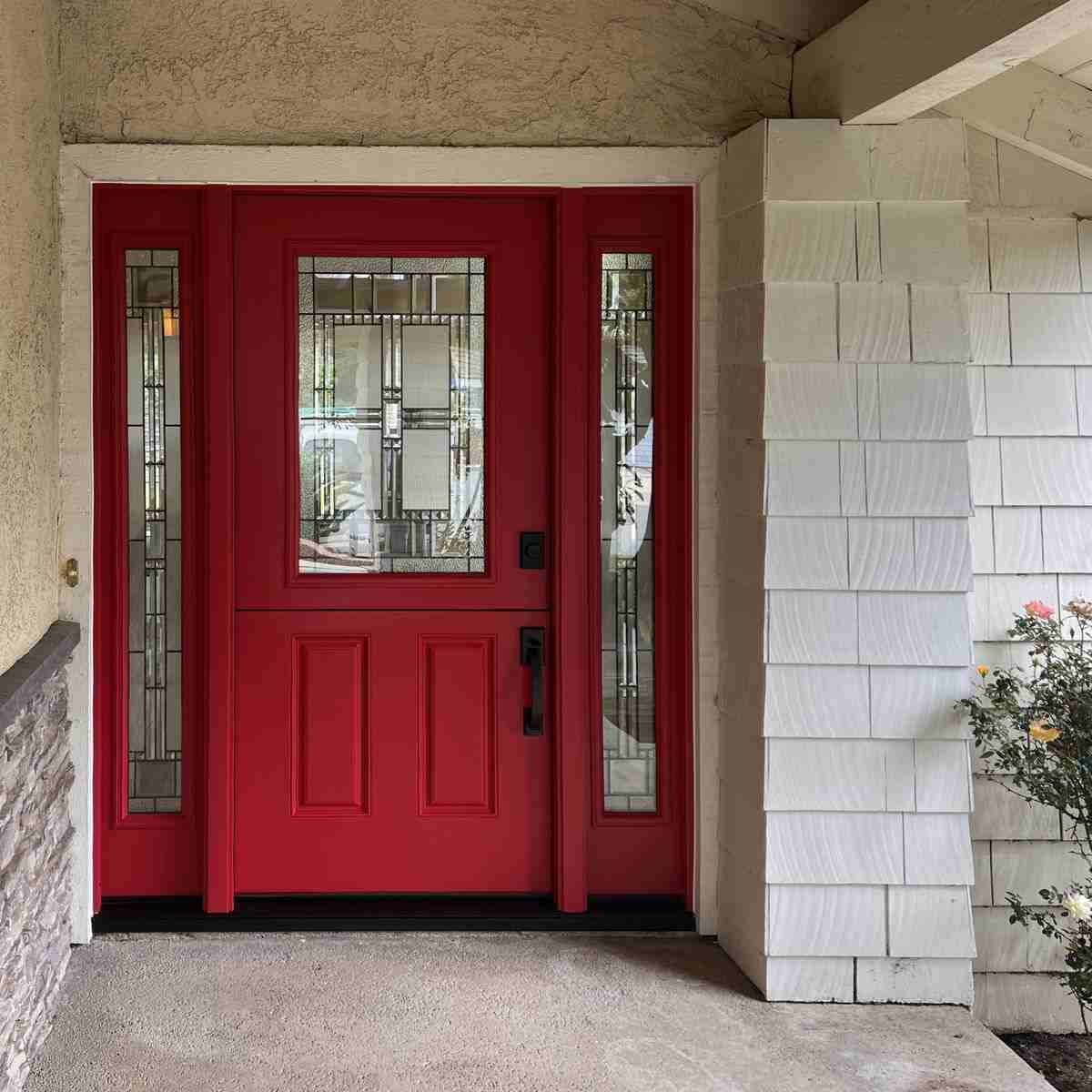 Red door with stained glass on white house