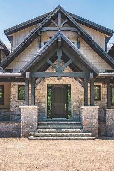 Stone house with wooden door and black roof