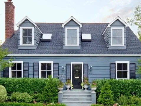 Slate blue house with white trim and stairs and railing