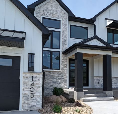 Stone on white house with black trim