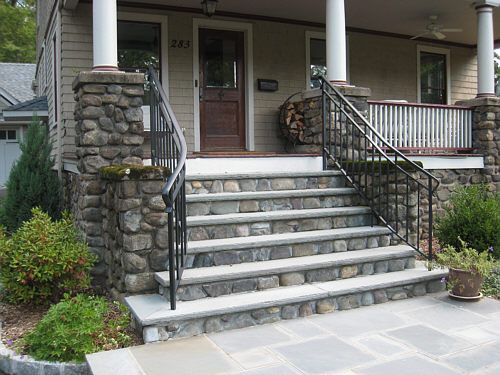 Stone staircase with railings and wooden house and door
