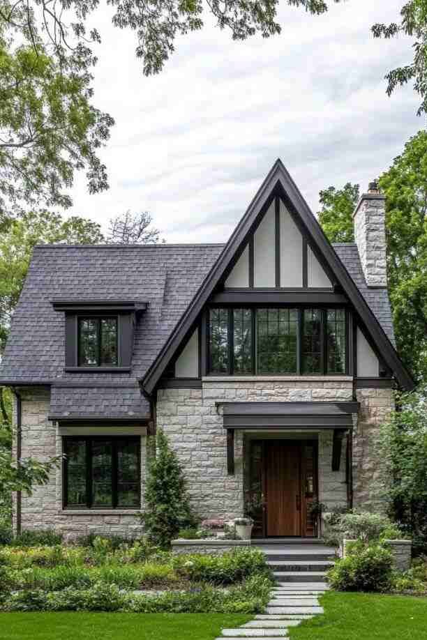 Tudor-style light grey house and wooden door and garden outside of the house 