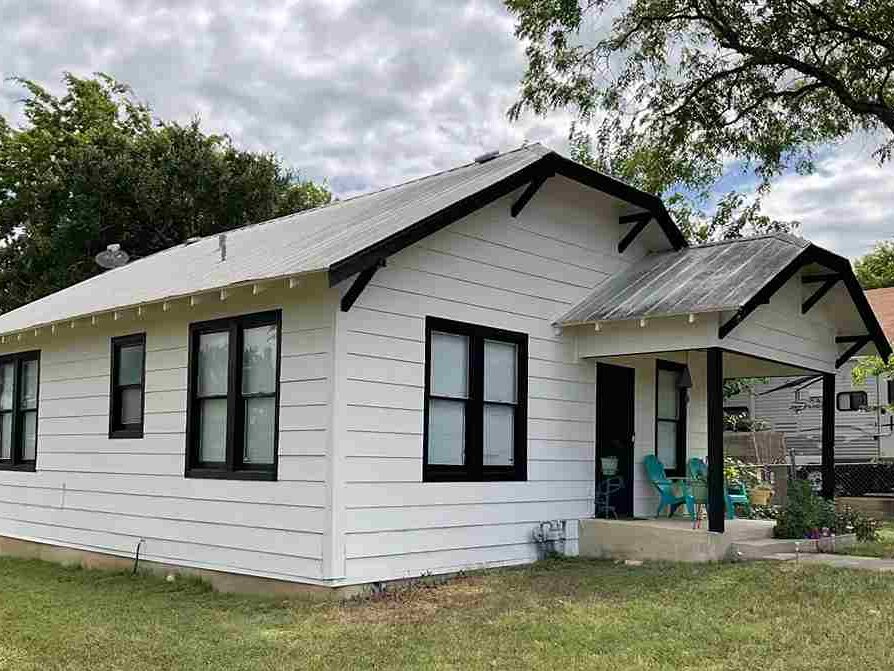 A white house with black trim and windows 