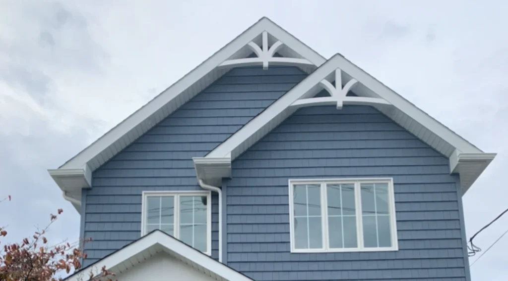 White gable roof on blue house and white trim windows
