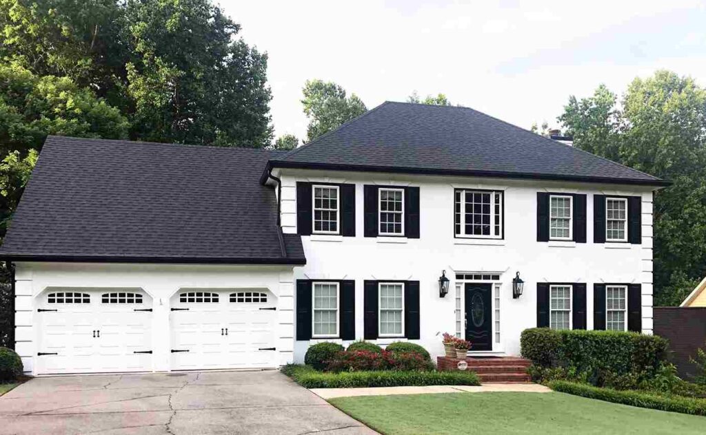 White house with black trim and windows and black shutters