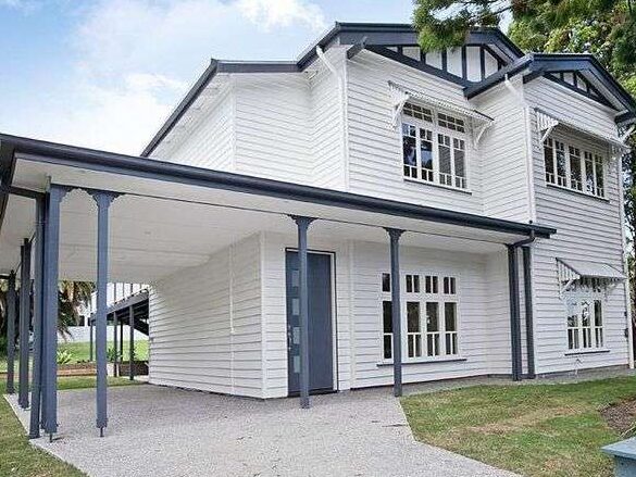 White house with blue trim and blue pillars and white windows