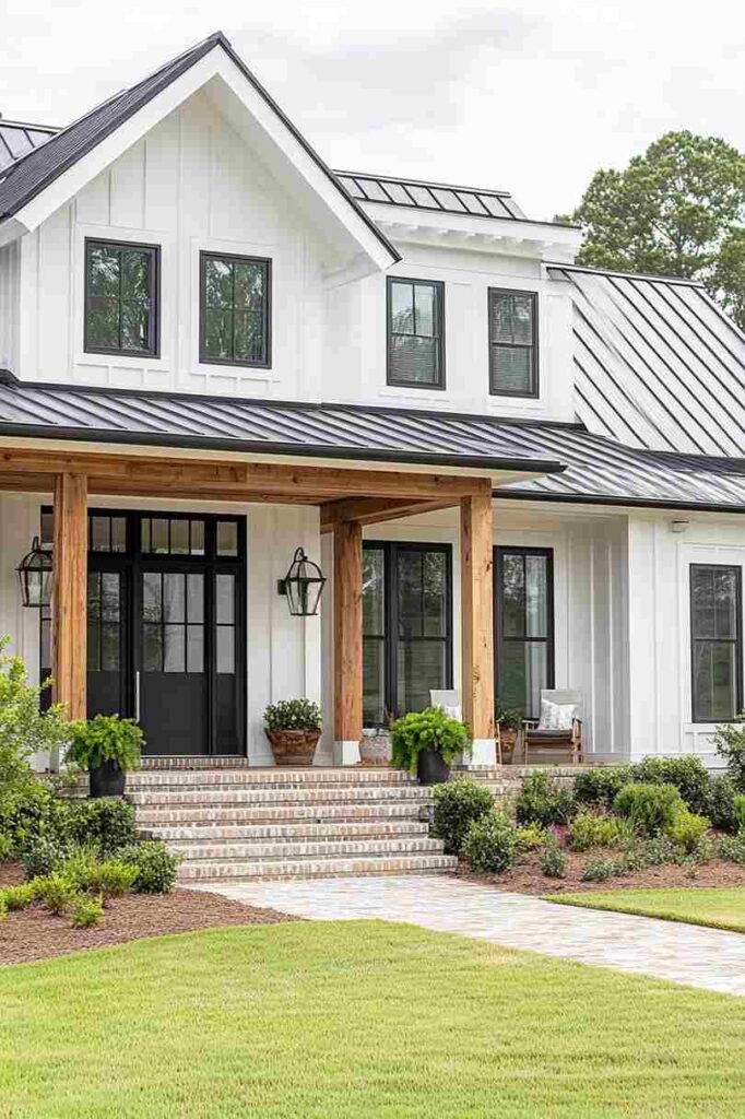 White wood house with black glass windows and garden outside of the house