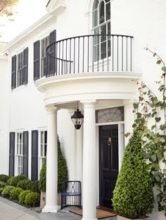 Black curved balcony on white house