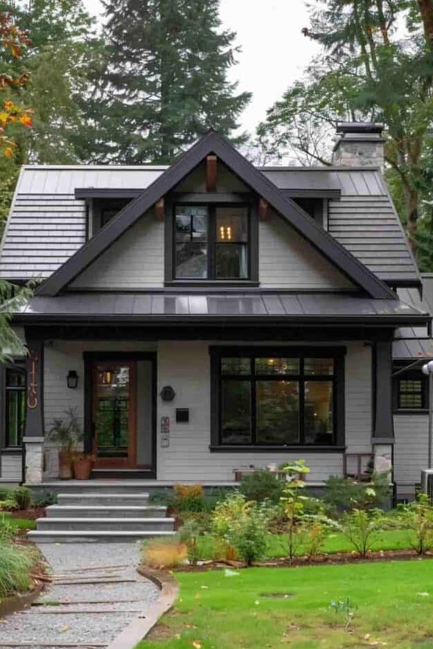 Grey house with black framed window and wooden framed glass door garden outside of the house