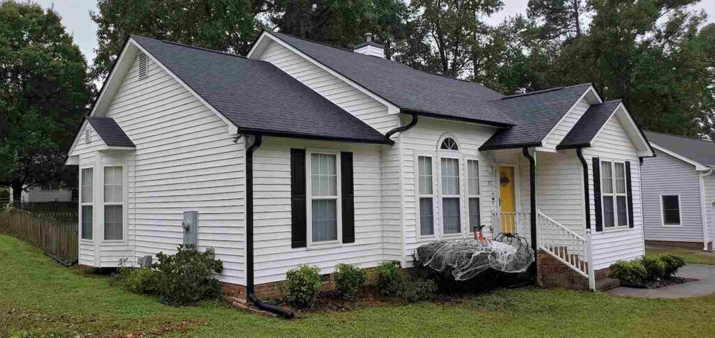 Black gutters and downspouts garden outside of the house