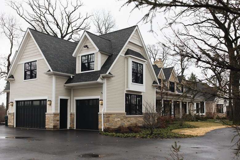 A cottage and black roof and  black trim window 