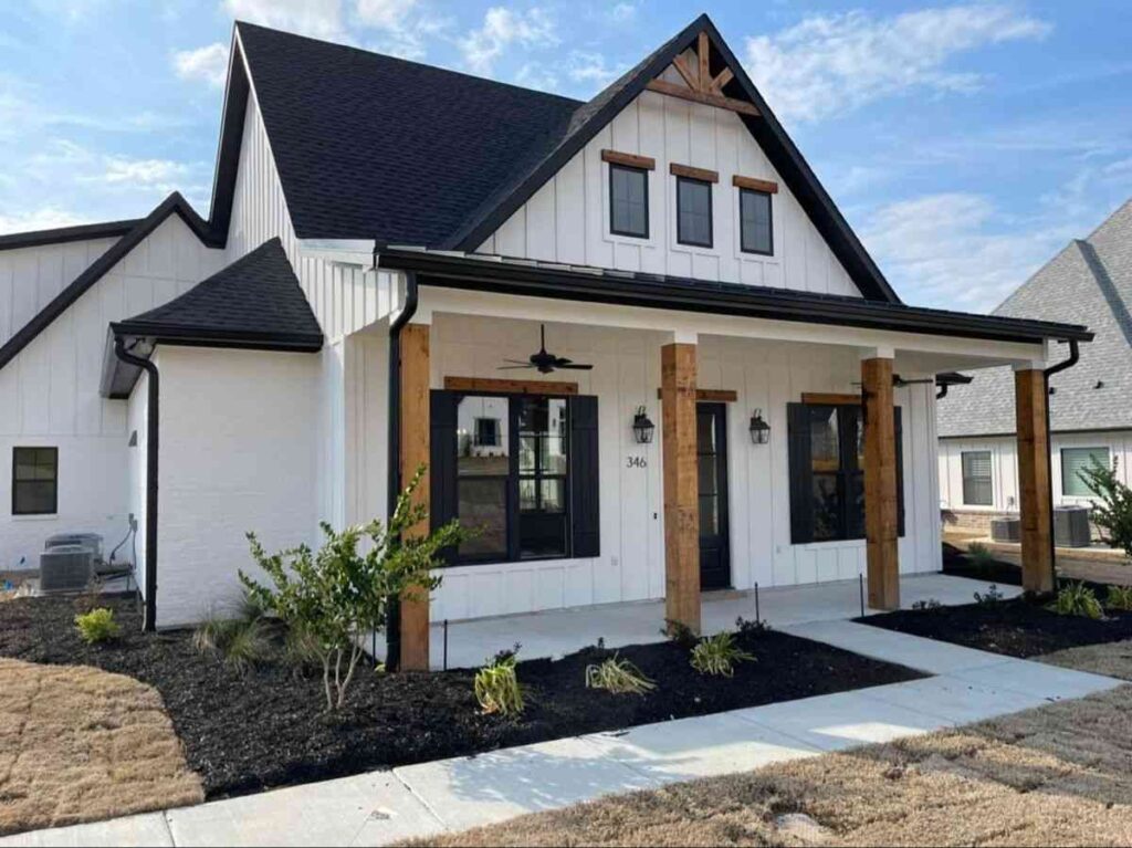 Black roof on white house and wooden accents