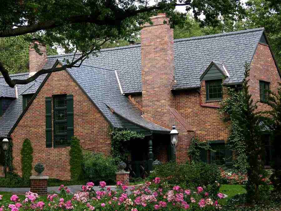 Red brick house with shingle roof and black windows
