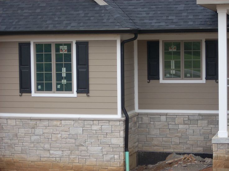 Tan house with black shutter and gutter and white trim