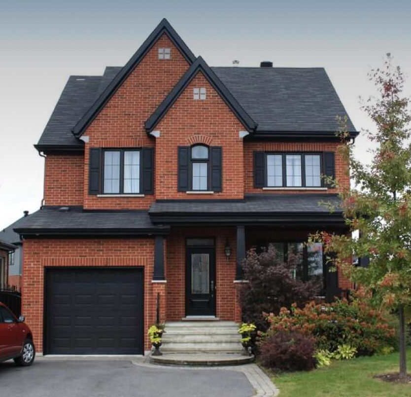 Red house with black shutter and glass windows 