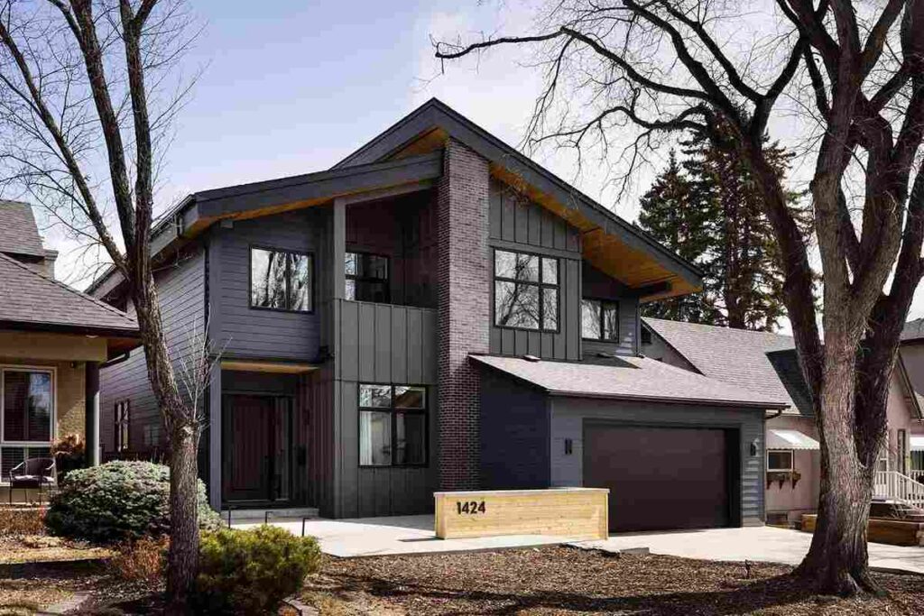 A black sidling and gray house and house no. on wooden wall and wood garage 