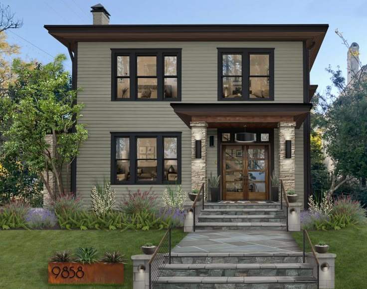Sage green house with black trim and wooden front door and lights on the both side of the wall